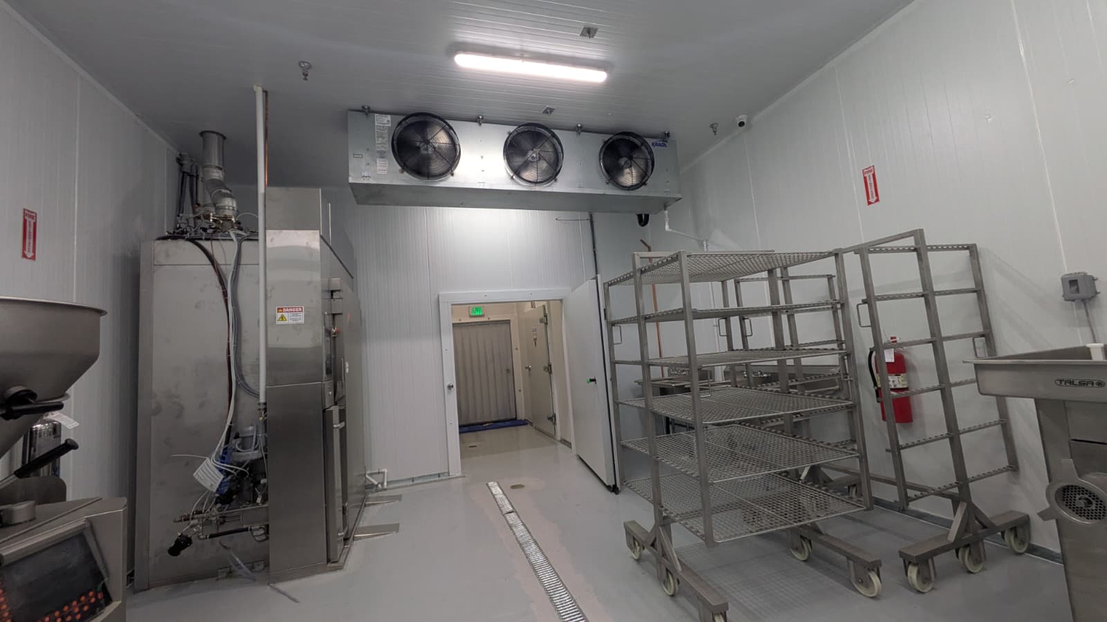Walk-in cold room with evaporator fans and stainless steel equipment