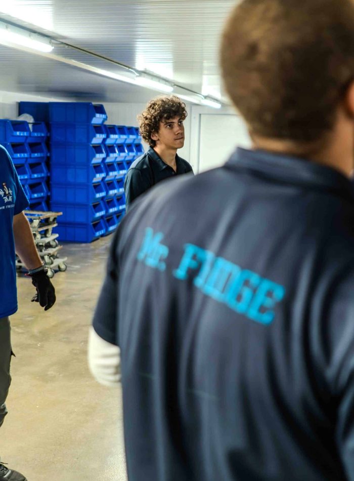 Mr. Fridge team members inside a food-production facility